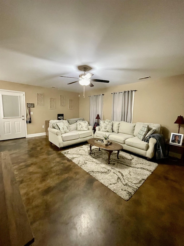 living room featuring ceiling fan, finished concrete floors, baseboards, and visible vents