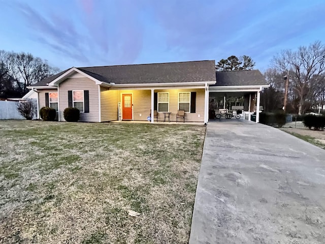 ranch-style house featuring covered porch, concrete driveway, a front yard, and fence