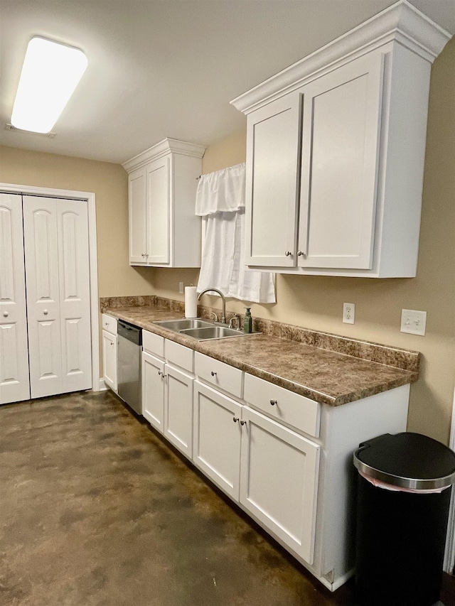 kitchen with dishwasher, dark countertops, a sink, and white cabinetry