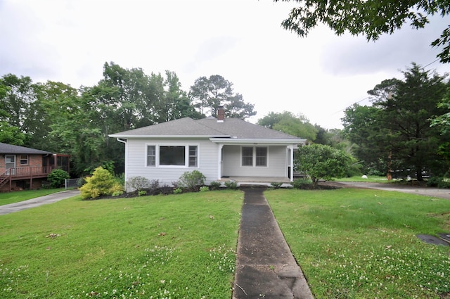  - bungalow-style house with a porch, a chimney, and a front yard