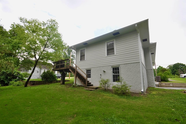  - back of house with stairs, a deck, a yard, and central AC