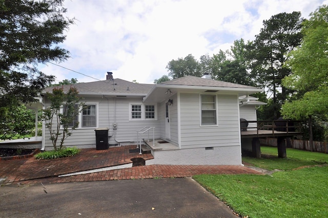  - rear view of property featuring a yard, a deck, and a patio area