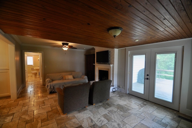 - living area with french doors, stone tile flooring, wood ceiling, crown molding, and ceiling fan