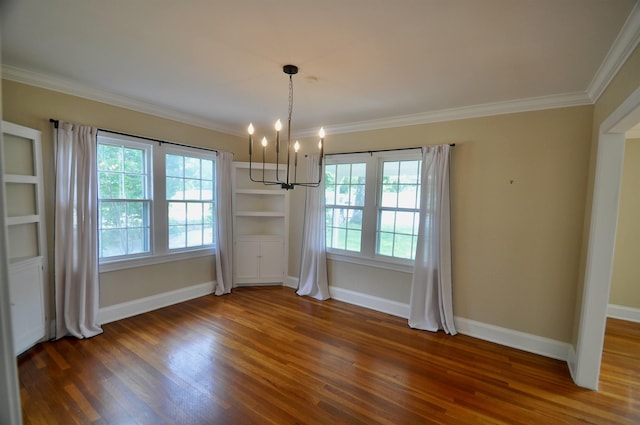  - unfurnished dining area with a chandelier, wood finished floors, plenty of natural light, baseboards, and ornamental molding