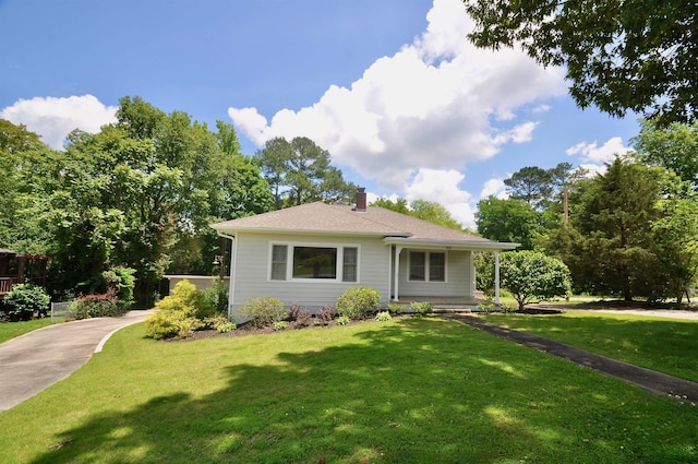  - view of front of home featuring a chimney and a front yard