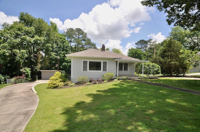  - view of front of property with a chimney and a front yard