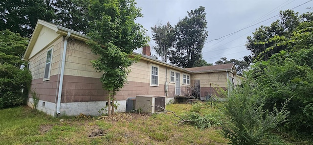  - view of property exterior featuring a chimney and crawl space