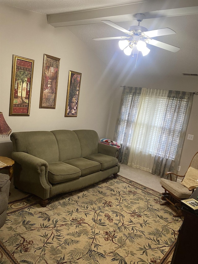 carpeted living room featuring lofted ceiling with beams and ceiling fan