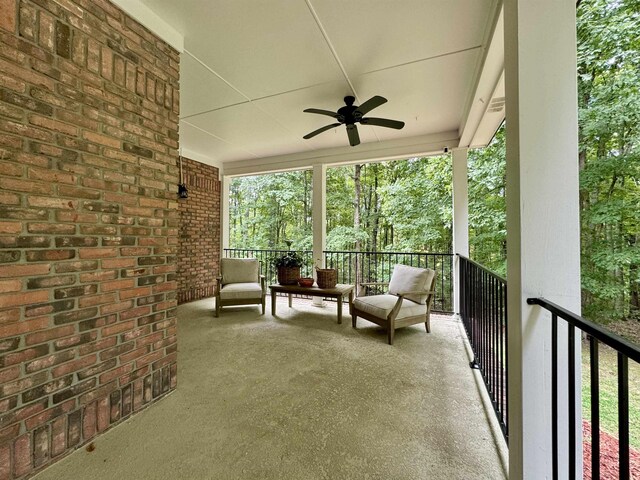 view of patio featuring ceiling fan and a balcony