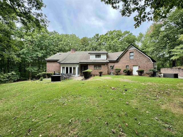 view of front of home with a patio and a front yard