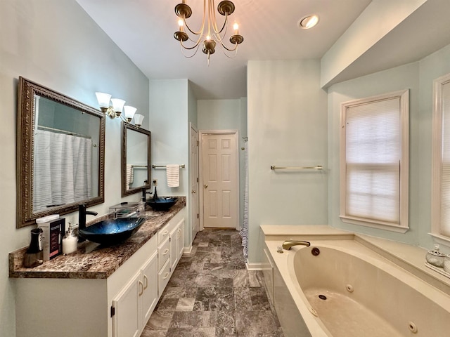 bathroom featuring a washtub, vanity, and a chandelier