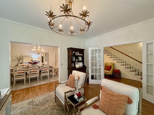 living area with hardwood / wood-style flooring, ornamental molding, french doors, and an inviting chandelier