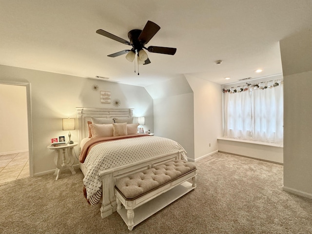 bedroom with light carpet, vaulted ceiling, and ceiling fan