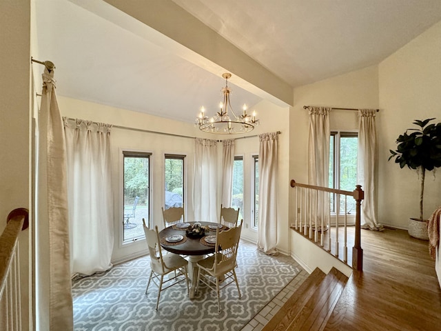 dining space featuring a notable chandelier, vaulted ceiling with beams, hardwood / wood-style floors, and a wealth of natural light