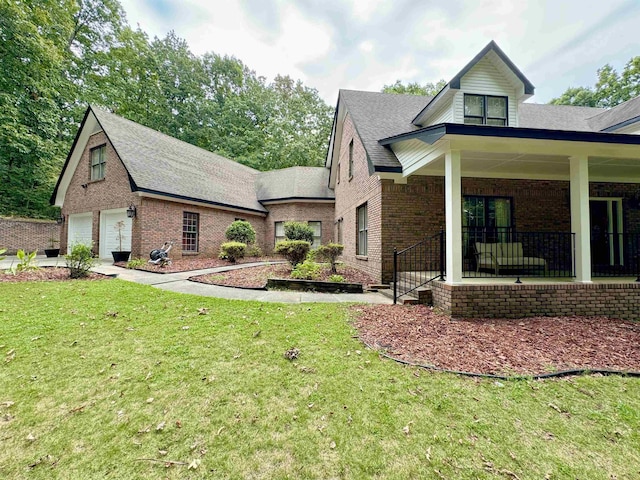 exterior space featuring a lawn, covered porch, and a garage