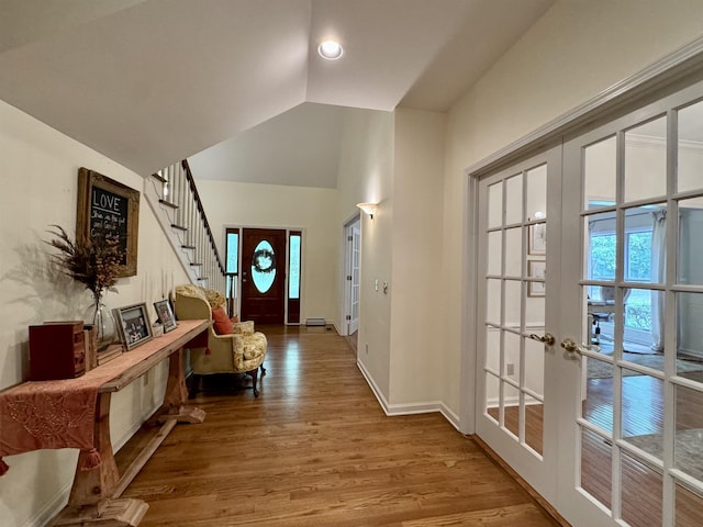 interior space with a wealth of natural light, french doors, hardwood / wood-style floors, and lofted ceiling