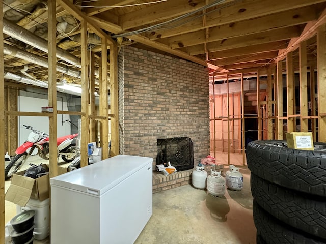 misc room featuring concrete flooring and a fireplace