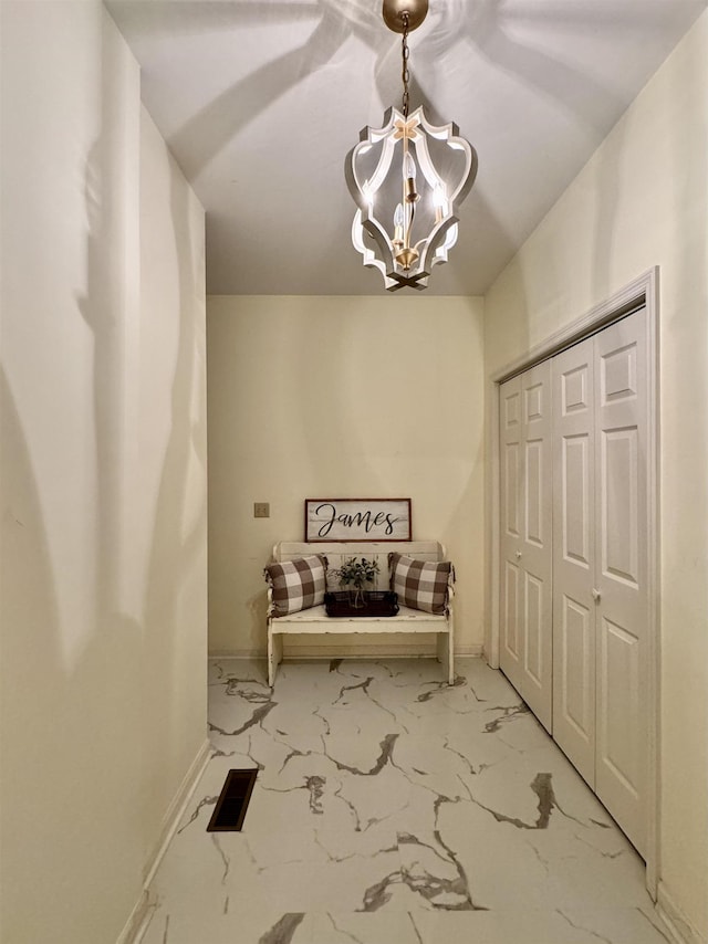 unfurnished room featuring a chandelier