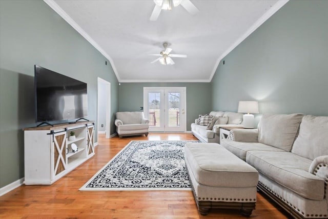 living room featuring ceiling fan, lofted ceiling, ornamental molding, and hardwood / wood-style floors