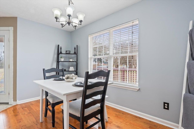 dining space with an inviting chandelier and wood-type flooring