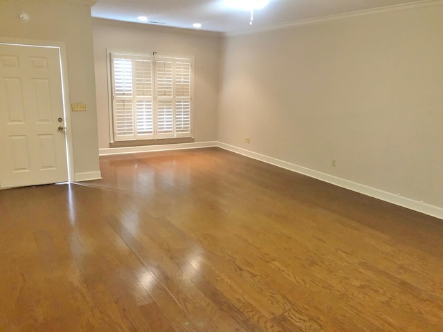 unfurnished room featuring dark hardwood / wood-style floors and ornamental molding