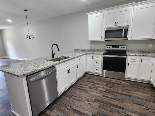 kitchen featuring pendant lighting, sink, kitchen peninsula, white cabinetry, and stainless steel appliances