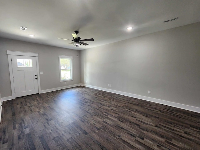 entrance foyer with ceiling fan and dark wood-type flooring