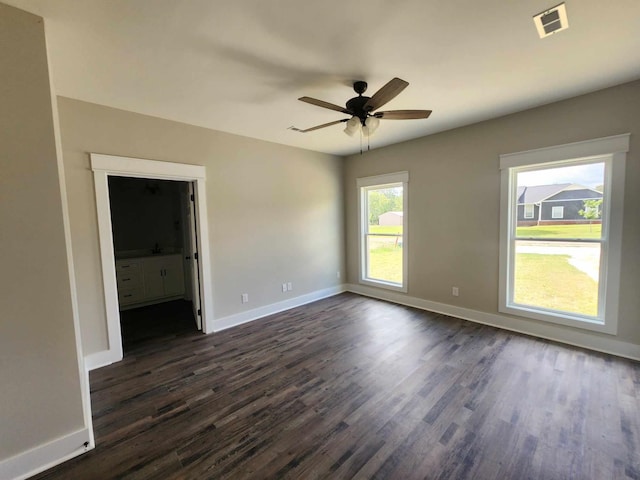 empty room with dark hardwood / wood-style flooring and ceiling fan