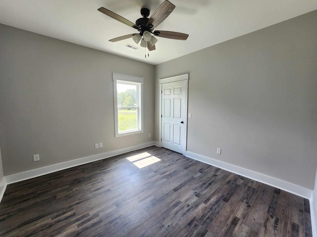 unfurnished room featuring ceiling fan and dark wood-type flooring