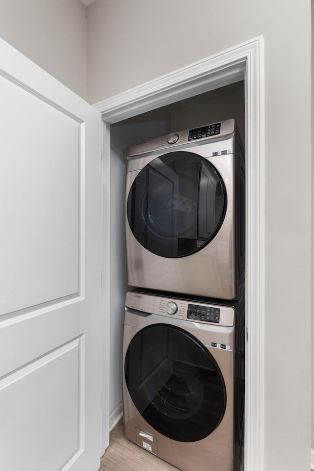 washroom featuring stacked washer and dryer