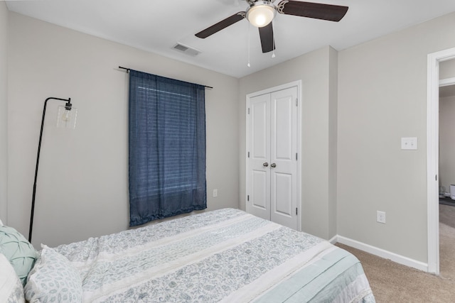 bedroom with carpet, ceiling fan, and a closet