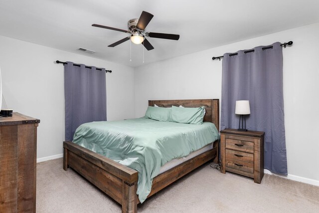 bedroom with ceiling fan and light carpet