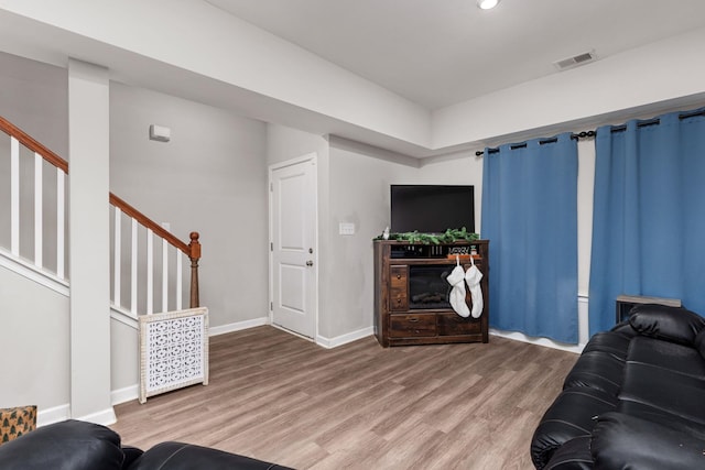 living room featuring hardwood / wood-style flooring and a fireplace