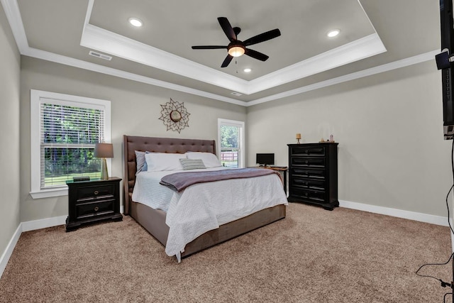  - carpeted bedroom with a tray ceiling, ornamental molding, baseboards, recessed lighting, and ceiling fan