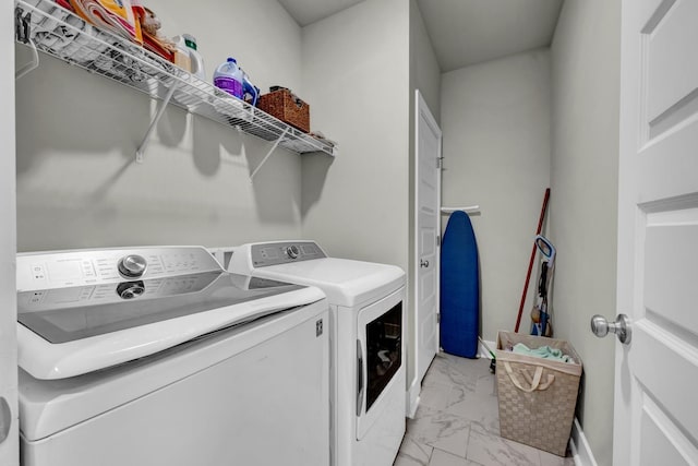  - washroom with light marble finish flooring and washer and dryer
