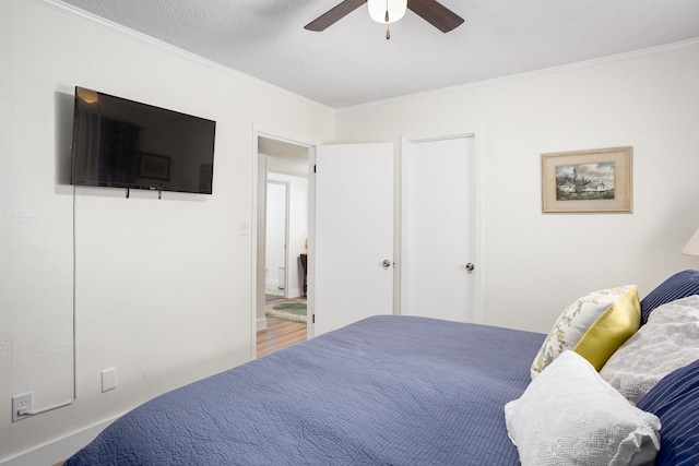 - bedroom with crown molding, a ceiling fan, and wood finished floors