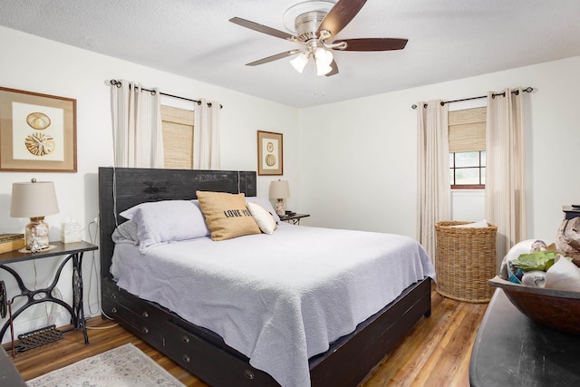  - bedroom with wood finished floors and a ceiling fan