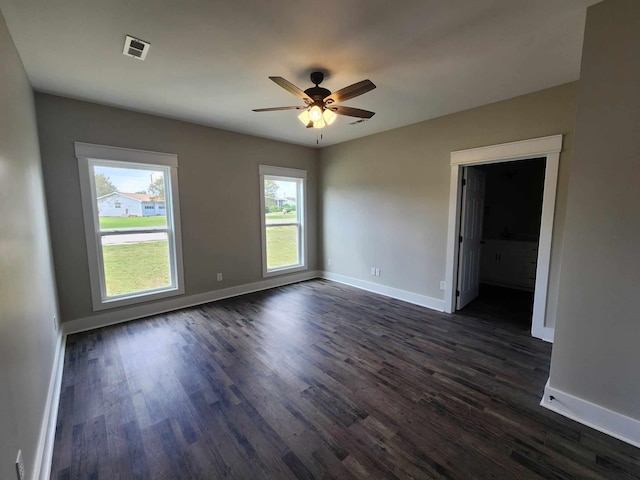 empty room featuring ceiling fan and dark hardwood / wood-style flooring