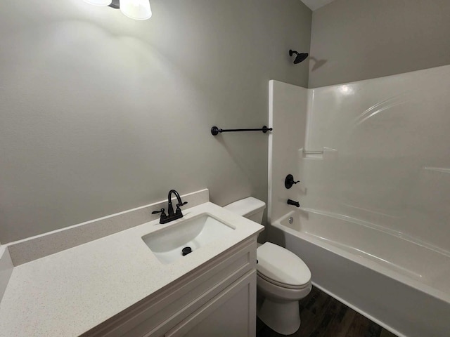 full bathroom featuring hardwood / wood-style floors, vanity, toilet, and washtub / shower combination