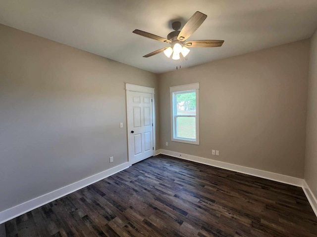 unfurnished room featuring ceiling fan and dark hardwood / wood-style flooring