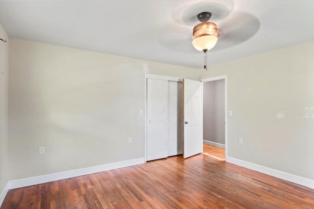 spare room with hardwood / wood-style floors and ceiling fan