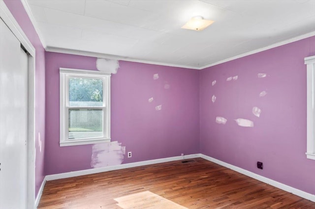 unfurnished room with crown molding and hardwood / wood-style flooring