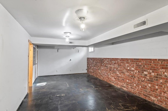 basement featuring brick wall