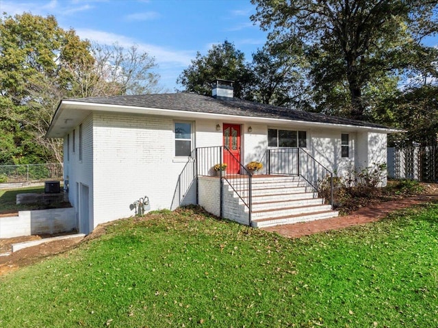 single story home featuring a front yard, a garage, and central air condition unit