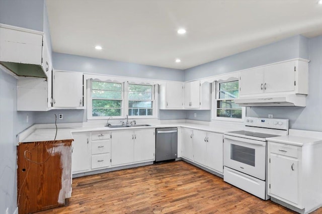 kitchen featuring stainless steel dishwasher, a wealth of natural light, sink, white electric range, and white cabinetry