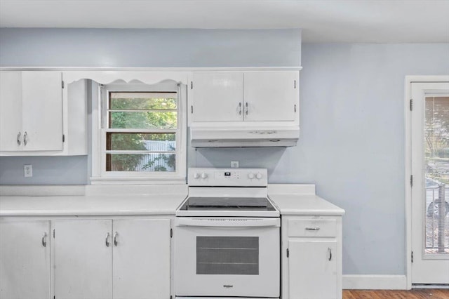 kitchen with light wood-type flooring, white cabinetry, and electric stove