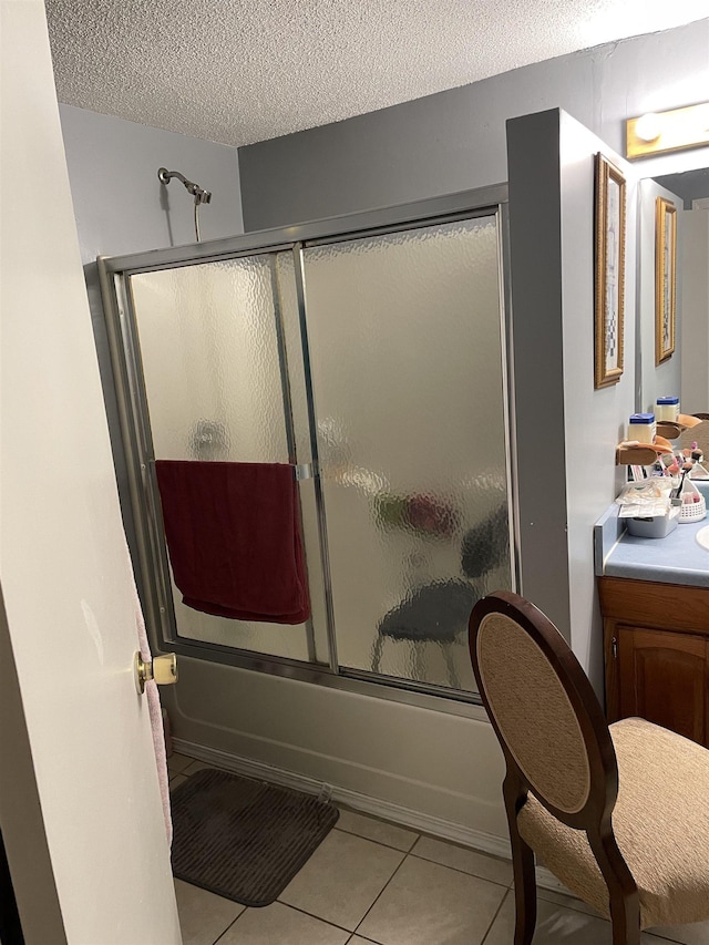 3119 Kent Rd, Ms, MS 38876 - bathroom featuring tile patterned flooring, bath / shower combo with glass door, vanity, and a textured ceiling
