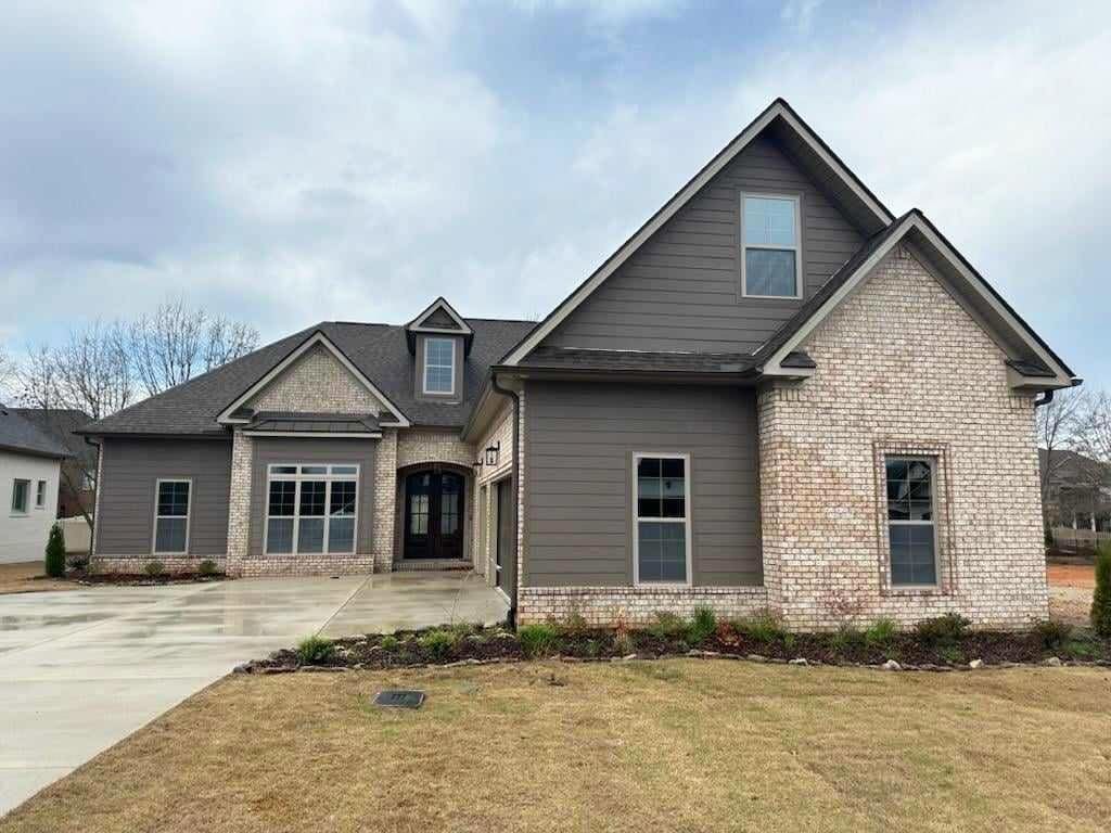 craftsman house with french doors and a front lawn