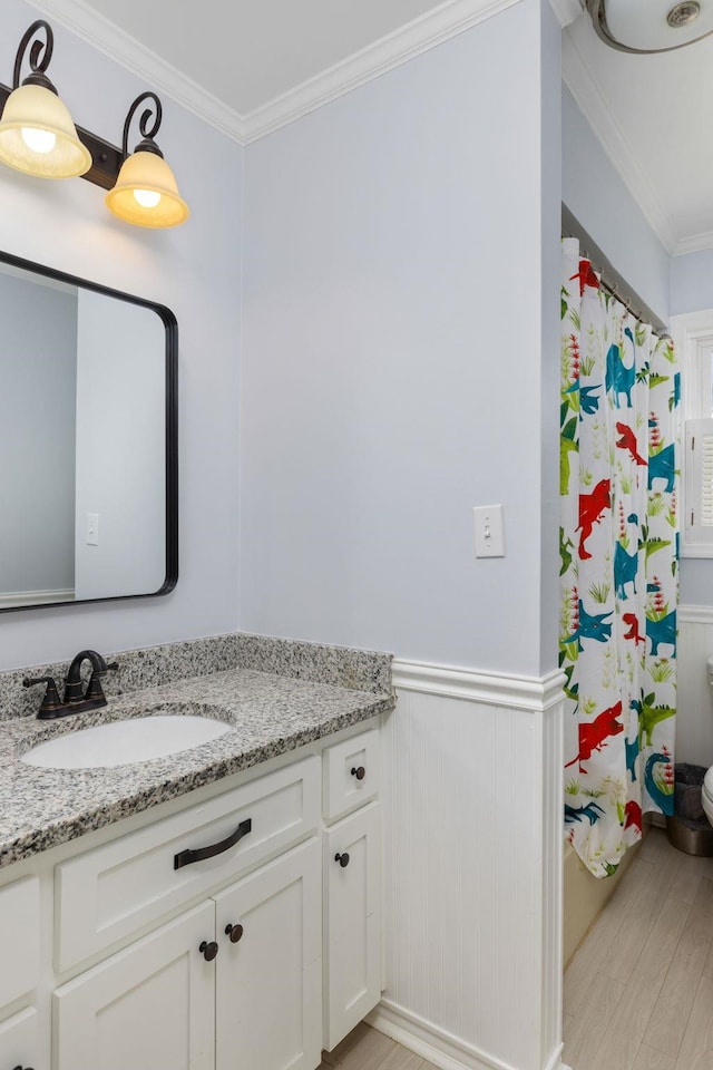 bathroom featuring crown molding, vanity, a shower with shower curtain, and hardwood / wood-style flooring