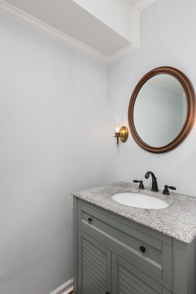 bathroom with vanity and ornamental molding